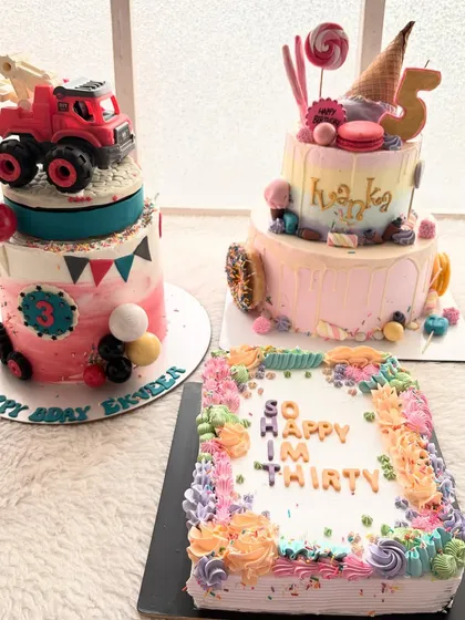Three very different cakes for three very different celebrations. A construction truck cake, a candy-themed cake, and a sheet cake for a 30th birthday.
