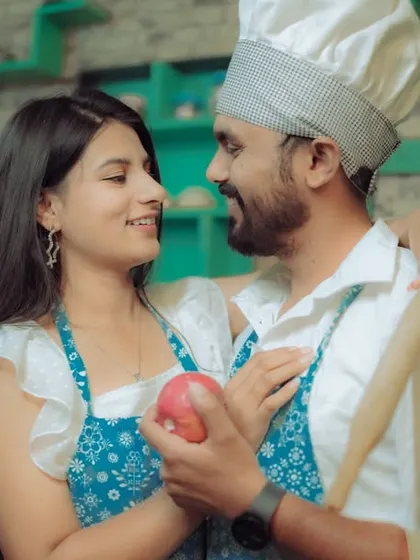 Love is cooking up something beautiful! This couple shares a laugh in a quirky kitchen setting, a perfect example of a themed pre-wedding shoot that reflects shared interests and creates fun, natural interactions.