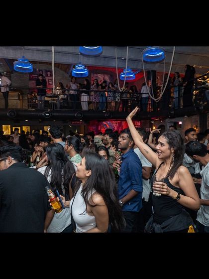 A shot of the crowd completely engaged with the performance. Everyone is focused on the music and the singer.