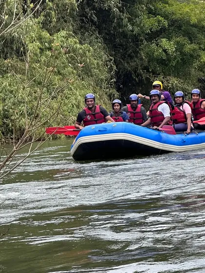 A team enjoys a calmer section of the Barapole river, surrounded by the lush greenery of Coorg. Our expeditions balance high-energy moments with peaceful scenery.
