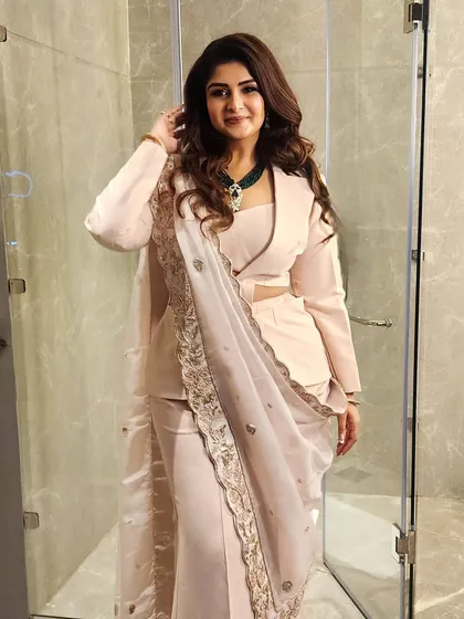 This is what I call power dressing with a soul. A modern, powder peach cutout powersuit paired with a traditional zardozi dupatta creates a look that is both authoritative and authentic, perfect for making a statement at any high-profile event.