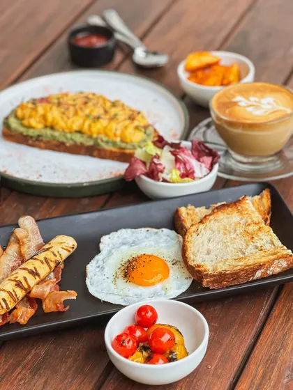 A breakfast spread shared with good company is one of life's simple pleasures. Here you can see my classic egg platter alongside a hearty avocado toast, with a fresh cup of coffee to bring it all together. There's something for every appetite.