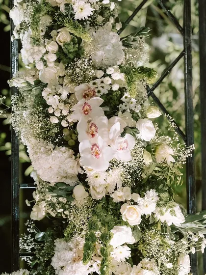 Another detail of the floral arch, highlighting the delicate beauty of the white phalaenopsis orchids.