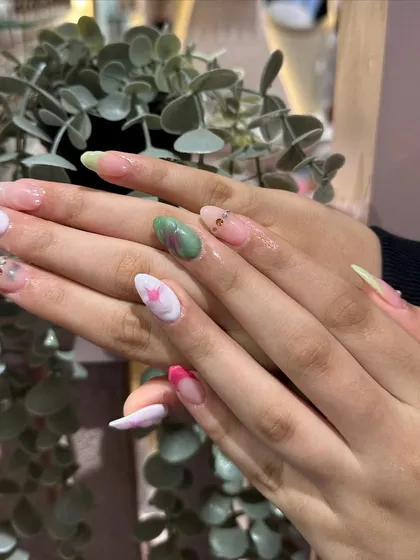 Another view of the delicate, artistic floral nail art, showing the blend of colors and subtle details.