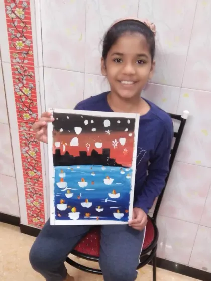 Avani, a 6th standard student, painted this scene of Diwali lamps on the river Ganga. She used poster colours to create a beautiful contrast between the night sky and the illuminated water.