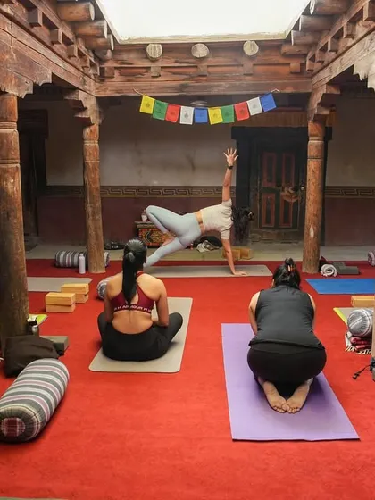 Guiding a student through Vasisthasana (Side Plank) during a workshop at our Ladakh retreat. The historic Nimmu House provided a beautiful backdrop for our practice.