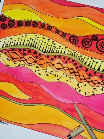 This beautiful piece, inspired by African ethnic patterns, is a work in progress. The student is using watercolors to create a warm background before adding intricate ink details.