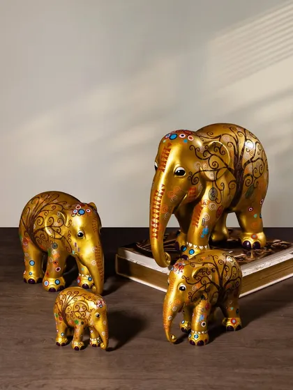 This set of golden elephant sculptures features intricate, hand-painted swirls and colorful gem-like details. They bring a sense of traditional luxury and artistic flair, while supporting a noble cause.