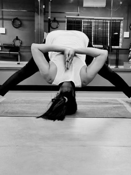 A wide-legged forward bend with a chest-opening clasp. This yoga pose not only stretches the legs and spine but also opens up the shoulders.