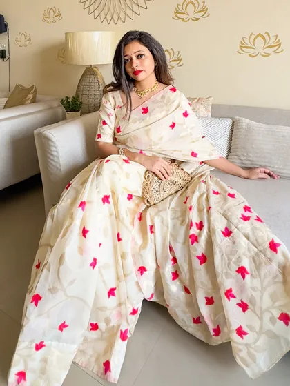 The saree spread out, showcasing the full beauty of the woven lotus pattern. This is a piece of wearable art.