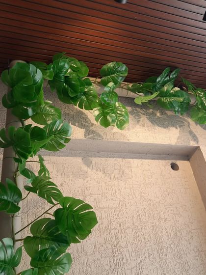 Artificial monstera vines are a great way to add a touch of the tropics to your balcony. They can be used to cover pipes or trail along the ceiling.