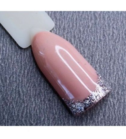 A sample of a glitter French tip. This design uses a classic nude base with a sparkling silver glitter tip for a modern and glamorous twist on a timeless look.