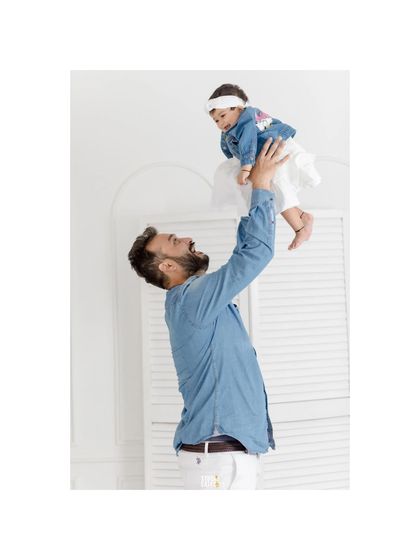 A father's pure joy as he lifts his baby daughter high in the air. This candid moment is full of energy, love, and happiness.