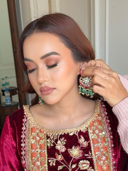 Beginning the wedding festivities with a serene look for a Guruji Satsang. This close-up shows the soft, earthy tones on the eyes and a matte nude lip.