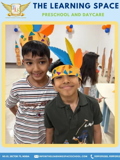 Two friends proudly show off the colorful headgear they made. These moments of shared creation and pride are what make our camp experience so joyful.