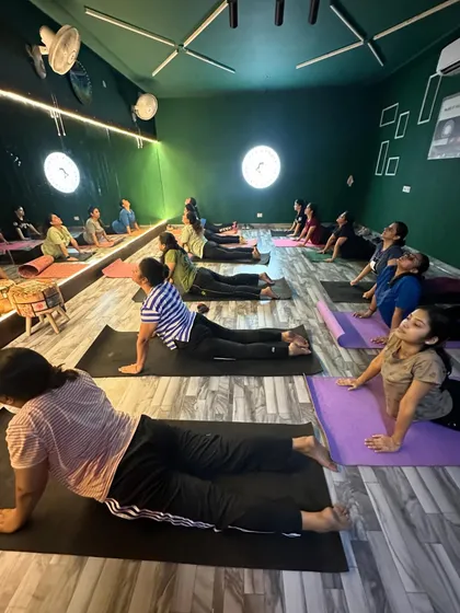 A class practicing the cobra stretch. This move helps improve spinal flexibility and strengthens the back, which is crucial for dancers.