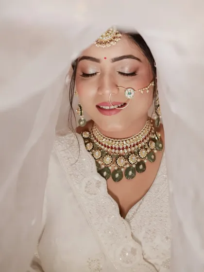 A blissful moment with eyes closed. This serene portrait of the bride under her veil is full of peace and beauty.