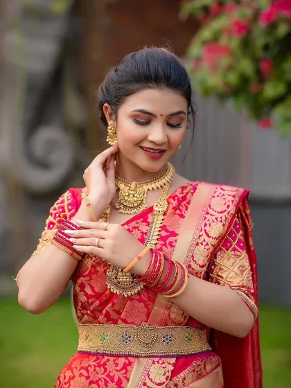 A beautiful portrait of the model, her hands adorned with henna, showcasing the complete South Indian bridal look.