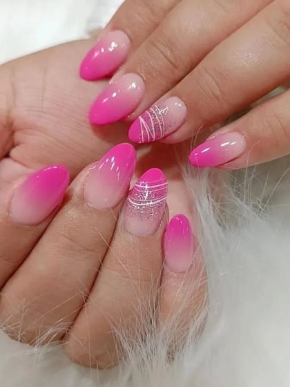 Another view of the vibrant pink ombre nails, showing how the different designs complement each other.