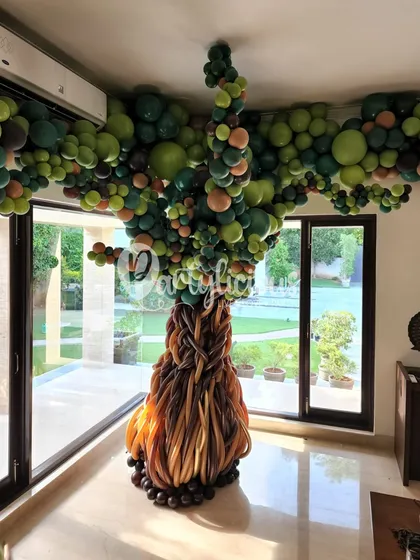 This indoor balloon tree is one of my proudest creations. We used advanced twisting techniques to create the textured bark and a full, leafy canopy that touches the ceiling, completely transforming the room.