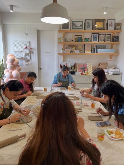 A group of women completely absorbed in a clay handbuilding session. Our studio provides a peaceful and focused environment to get lost in your art.