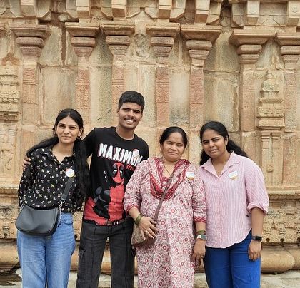 A small group posing in front of the intricate carvings at Lepakshi temple. This day trip combines spiritual and architectural wonders.