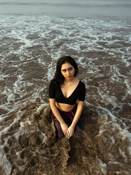 This shot, taken from a higher angle, shows the model surrounded by the patterns of the seafoam, creating a beautiful, natural frame.