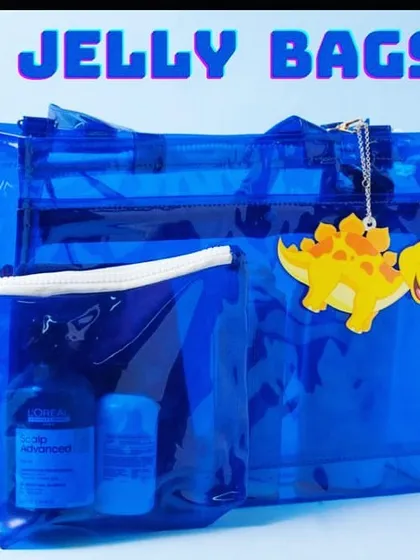 A close-up of the royal blue jelly bag, personalised with a dinosaur charm. These bags are durable and easy to clean.