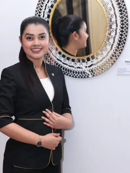 A visitor posing with a mirror artwork at the 'Aaina' exhibition.