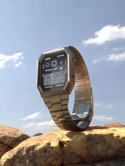 A photorealistic 3D model of a classic Casio watch, rendered in a bright, outdoor desert scene. This still image showcases my ability to create detailed models and place them in realistic, textured environments.