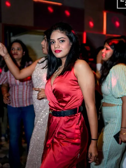 A guest in a stunning red dress, perfect for the Christmas party.