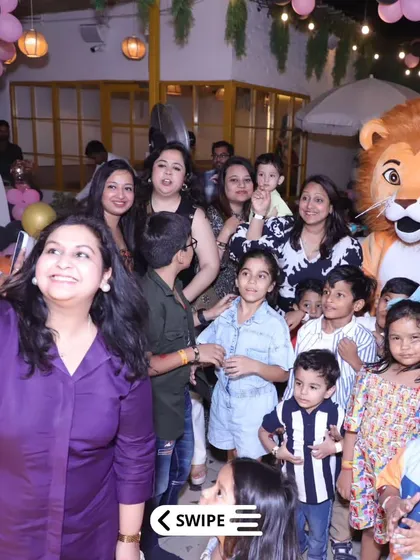 A big group selfie with the lion mascot. He's a celebrity at our parties and makes every photo more memorable.
