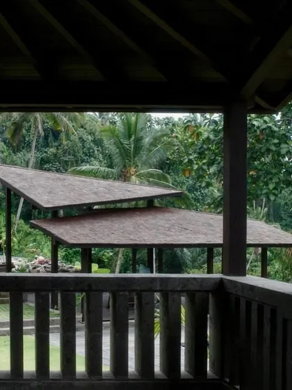 The layered, sloping roofs of pavilions at our Bali project, seen from a balcony. The design draws inspiration from traditional Balinese architecture while maintaining a contemporary feel.
