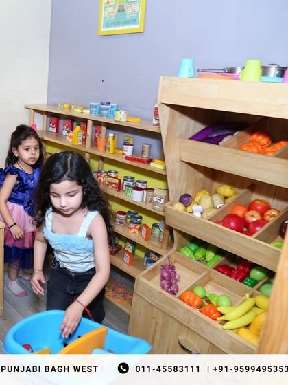 Little shoppers filling their carts in our mini grocery store, a fun and educational part of our pretend play world.