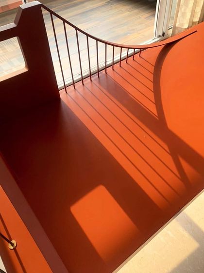A close-up of the Golden Gate Bridge swing, showing the detail of the suspension-style design and the play of sunlight and shadow on its surface.