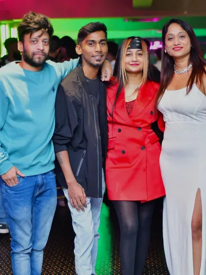 Posing with some friends and regulars at the club. I love connecting with the people who come out to support my music.