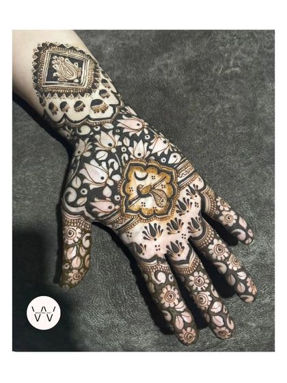 A single-hand view of a detailed Karwachauth design, showcasing a mix of floral and geometric patterns.