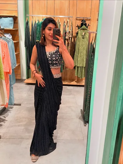 Another mirror selfie showcasing a beautiful black pre-draped saree, highlighting its modern and chic appeal for festive occasions.