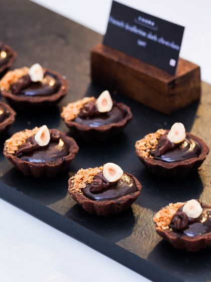 Decadent Ferrero Rocher and Belgian dark chocolate tartlets, another favourite from our catering menu. These mini desserts feature a crisp chocolate shell, a rich ganache filling, and a crunchy hazelnut topping.