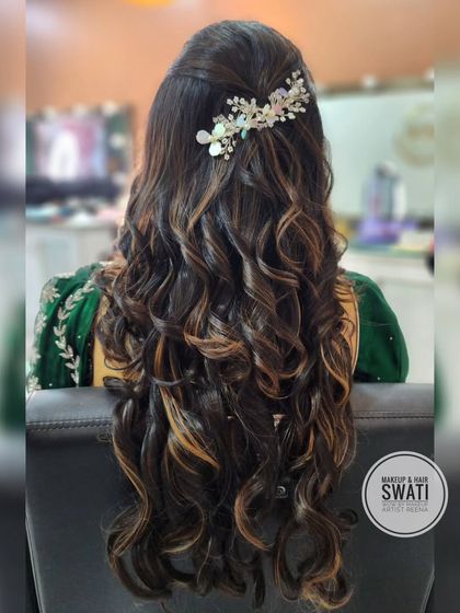 A half-up hairstyle with soft, highlighted curls for an engagement look. My artist Swati added a sparkling accessory to complete the style.