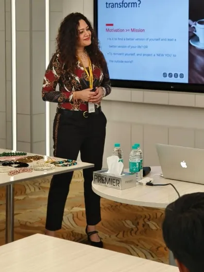 A close-up shot during a presentation. You can see a table with various accessories, which I use for hands-on demonstrations of styling and accessorizing principles.