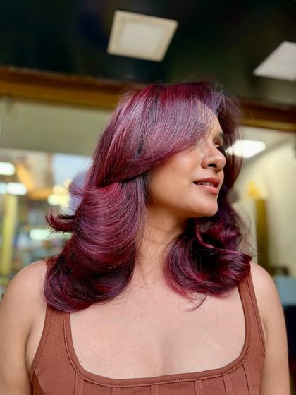 A beautiful red-violet balayage that’s perfect for the new year. The color is rich and dimensional, and the soft waves show off the seamless blend of tones. A happy client with a fresh new look.