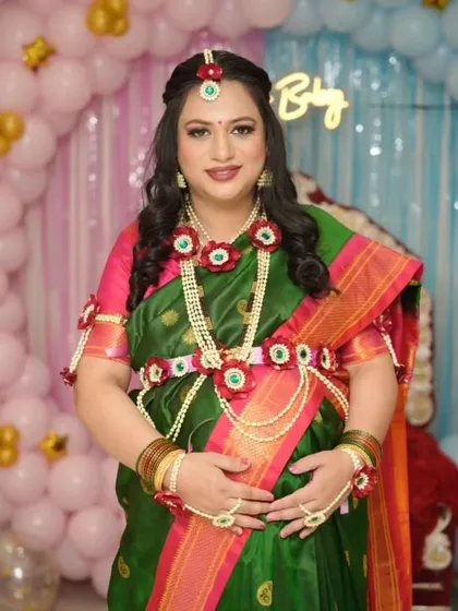 A full-length view of this traditional baby shower look. The makeup, hair, and floral jewelry all come together to create a beautiful and memorable style.
