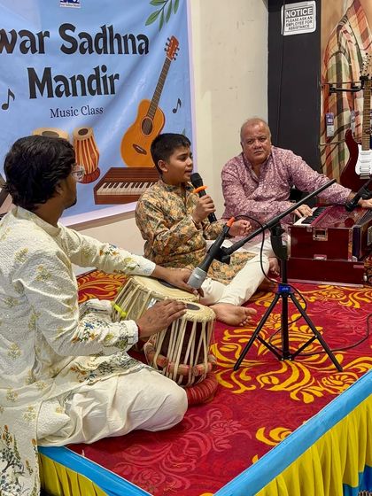 A student sings with heartfelt devotion, accompanied by harmonium and tabla. Our Guru Purnima Utsav is a space for soulful expression through Indian classical and semi-classical music.