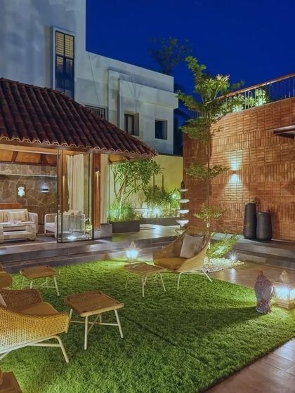 The outdoor seating area at night, illuminated to create a magical and inviting atmosphere for evening gatherings.