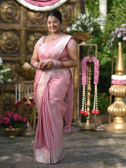 A full-length portrait of Dr. Namratha. The simple jewellery and fresh makeup create a look of understated elegance for her ring ceremony.