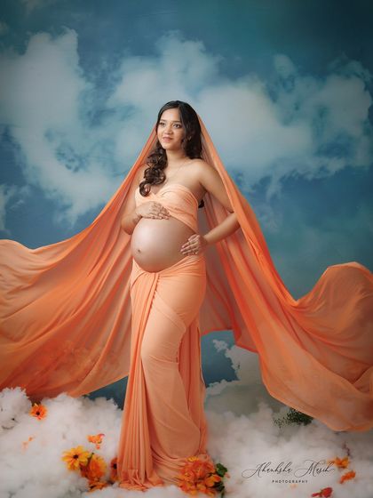 A beautiful variation of the cloud nine theme, with the orange fabric draped as a veil, creating a sense of mystery and divine grace.