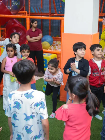 A group of children gathered during a birthday party, fully engaged and excited. Our play areas are designed to foster social interaction and shared moments of joy.