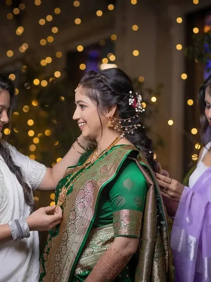 A sweet, behind-the-scenes moment as friends help the bride with her jewelry.