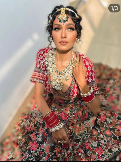 Another angle of the floral lehenga, showing the curly hair styling and the statement jewellery.